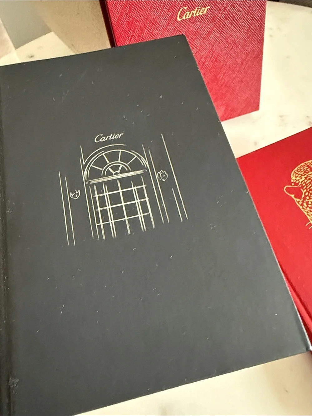 Cartier Red and Black Hardcover Notebooks with Gold Accents